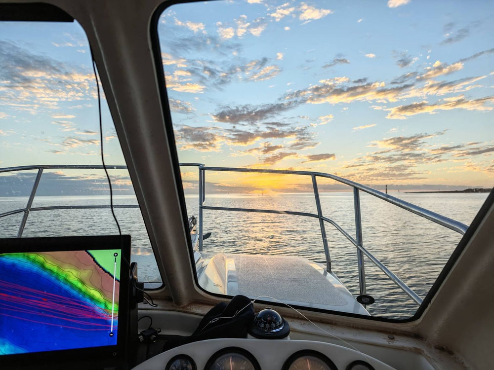 Sunrise from the helm with the sounder chart on screen